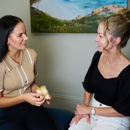 Dr Matildah showing spine model to patient