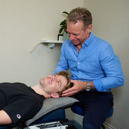 Dr Mike adjusting patients neck