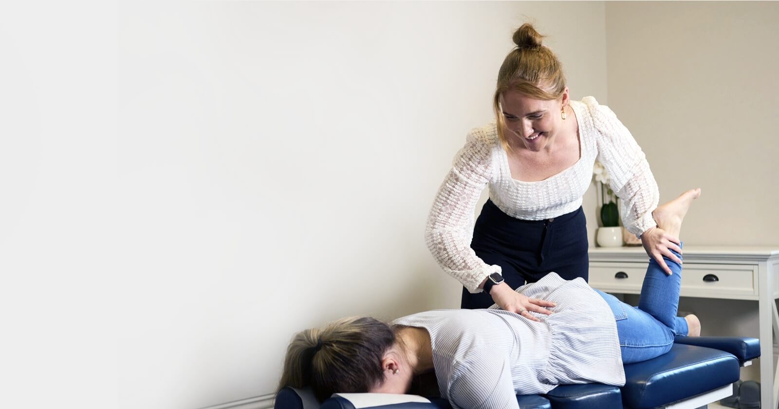 South Perth chiropractor adjusting patient laying on table