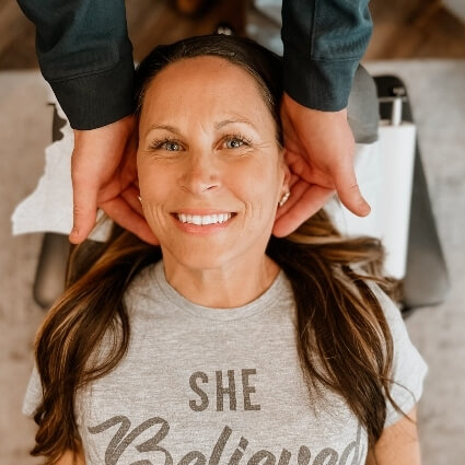 woman having neck adjusted