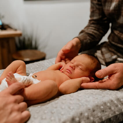 Dr. Jason adjusting a baby