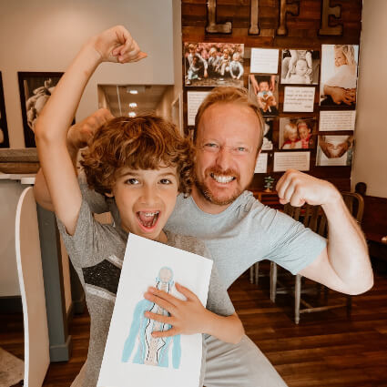 Dr. Jason flexing with child patient