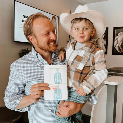 Dr. Jason with boy wearing cowboy hat