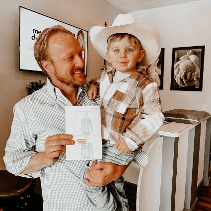 Dr J holding a young patient