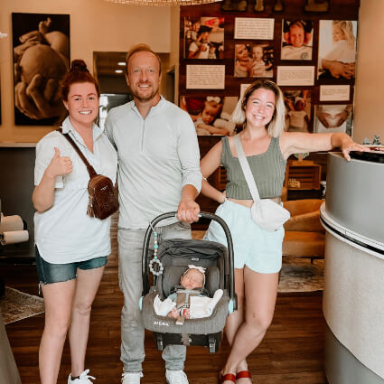 Dr. Jason standing at reception with a family of patients