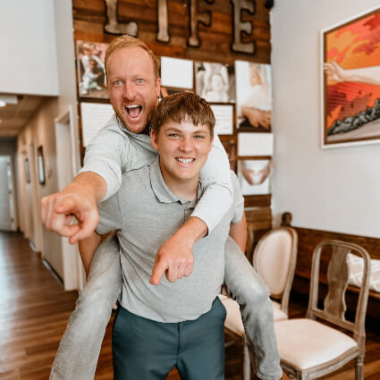 Dr. Jason jumping on young patient's back and pointing