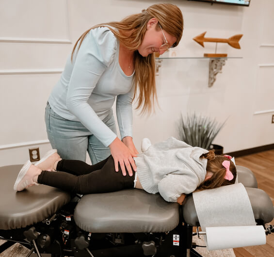 Chiropractor adjusting kid patient