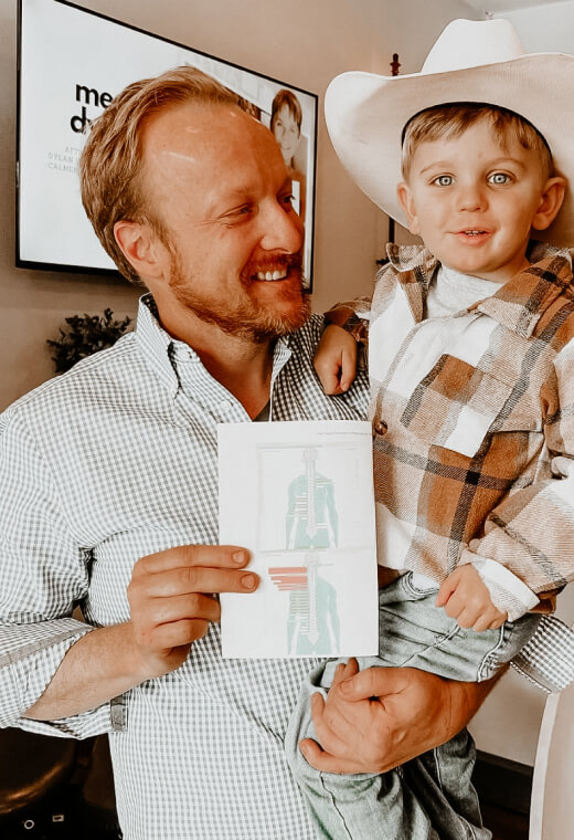chiropractor holding kid patient