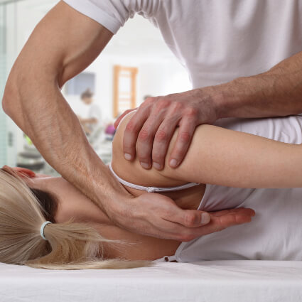 Female patient receiving a upper-back adjustment