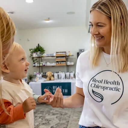 Chiropractor holding child's hand