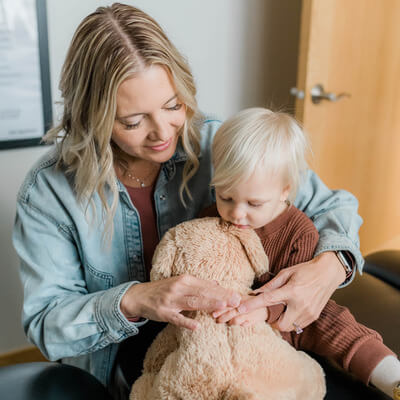 anxious child hugging teddy bear