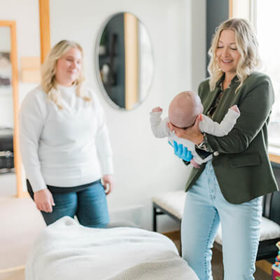 baby being held by Dr ShaRhae 