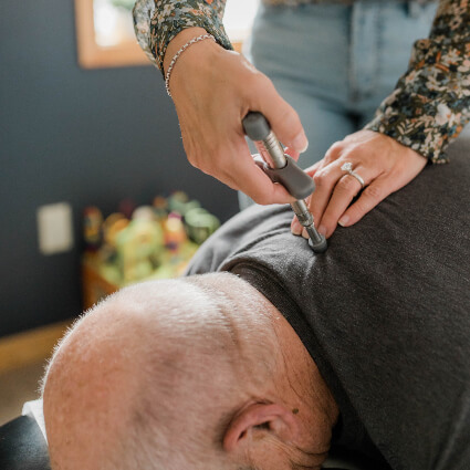 Chiropractor using activator for adjustment