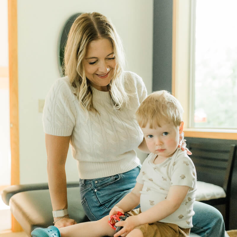 Eden Prairie chiropractor smiling down at a child