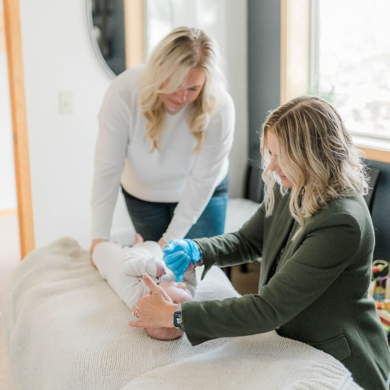 Eden Prairie chiropractor adjusting baby laying on table