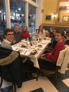 group of people eating dinner in restaurant