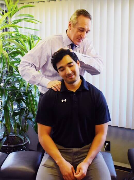 Chiropractor adjusting patients neck
