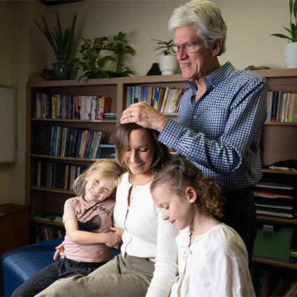 Dr. Sanders with a mom and daughters