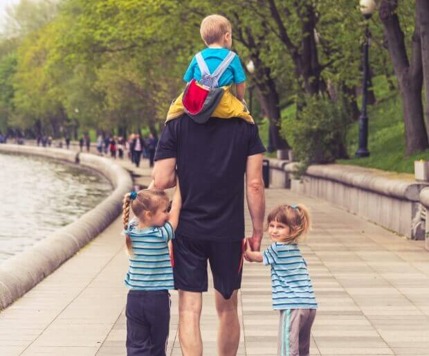 Dad out on a stroll with his three children