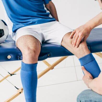 soccer player having a knee checked