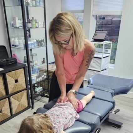 Dr Caplan adjusting childs back