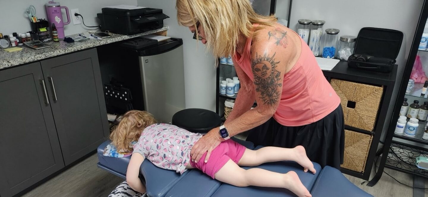Northeast Colorado Springs chiropractor Dr Michelle adjusting childs hips