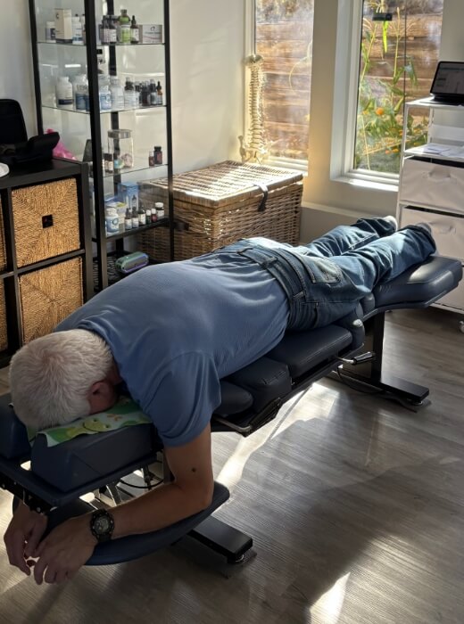 Northeast Colorado Springs chiropractor patient laying on chiropractic bed