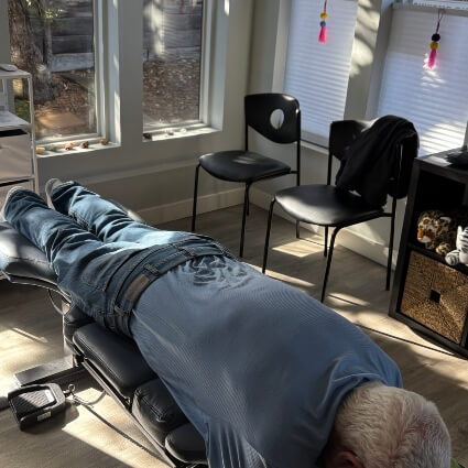 man laying on adjusting tabl