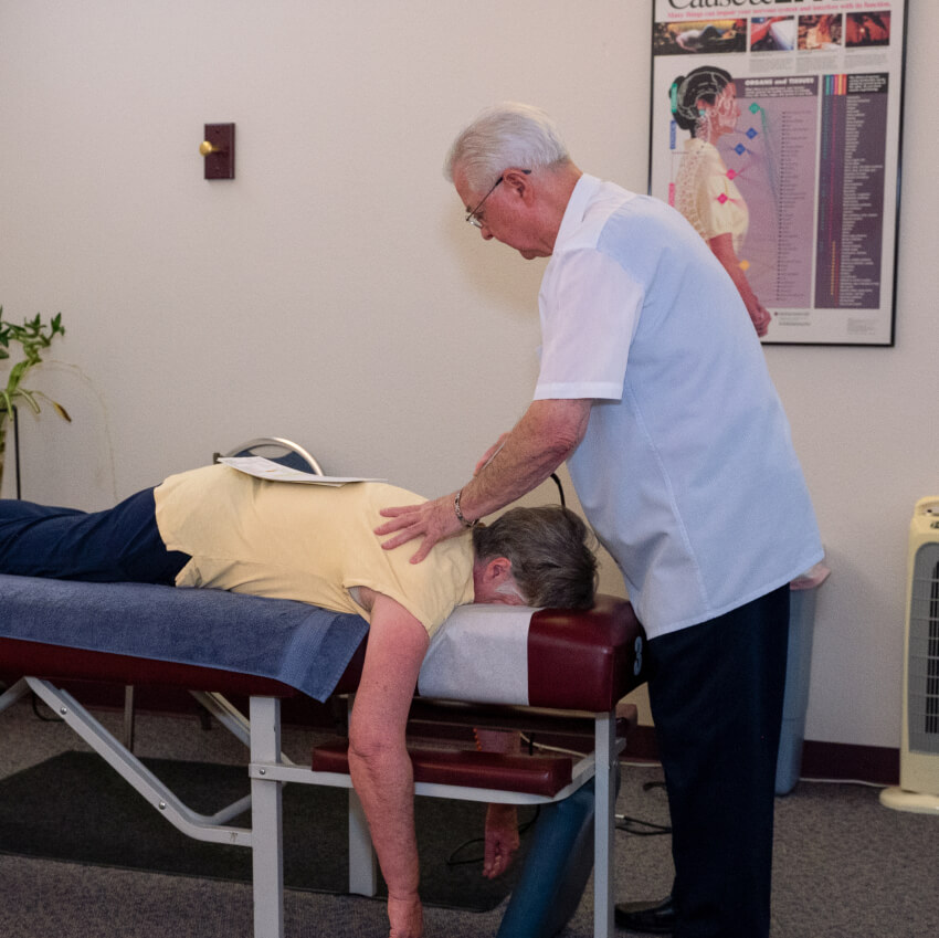 Dr Shows adjusting patients back