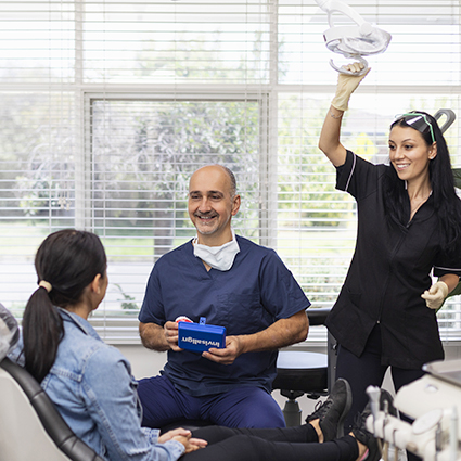 Dr George talking with patient and staff