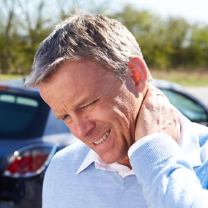 man holding neck in pain