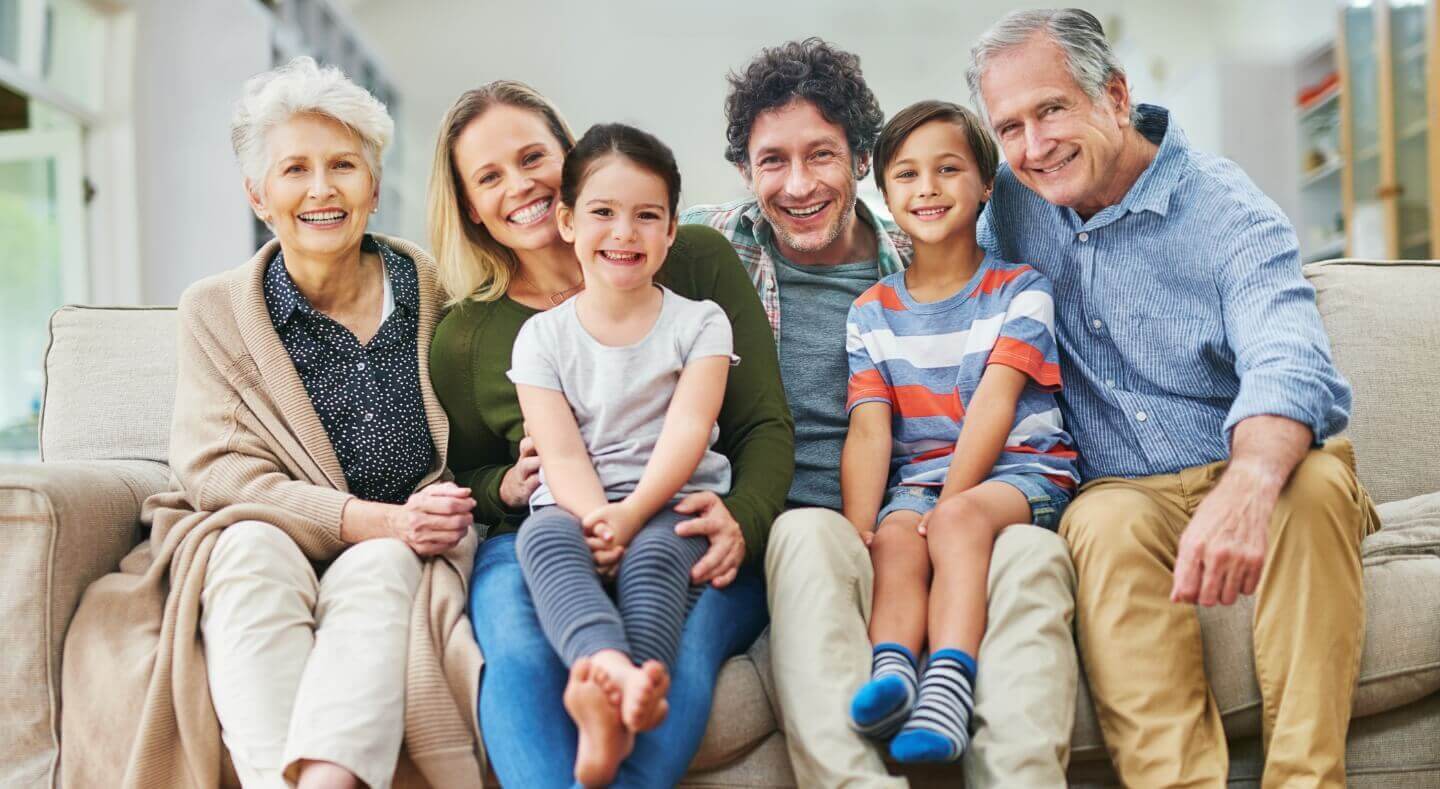 big happy family sitting on couch together