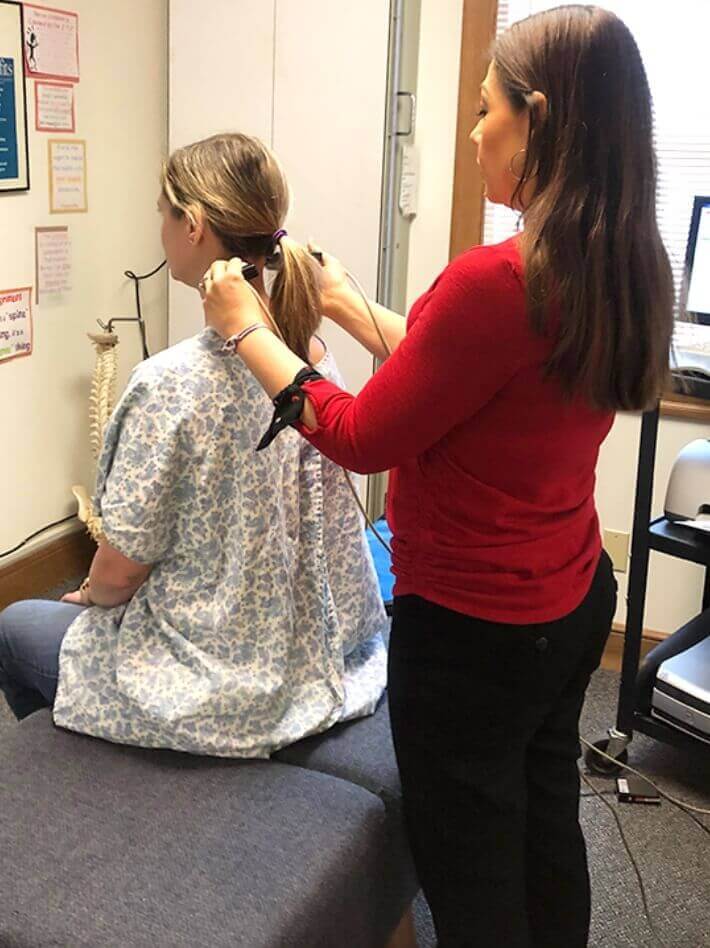 Spurback Family Chiropractic patient having neck scanned