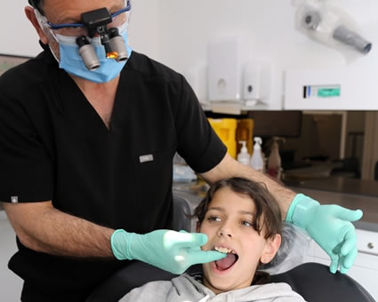 Dentist checking boys mouth
