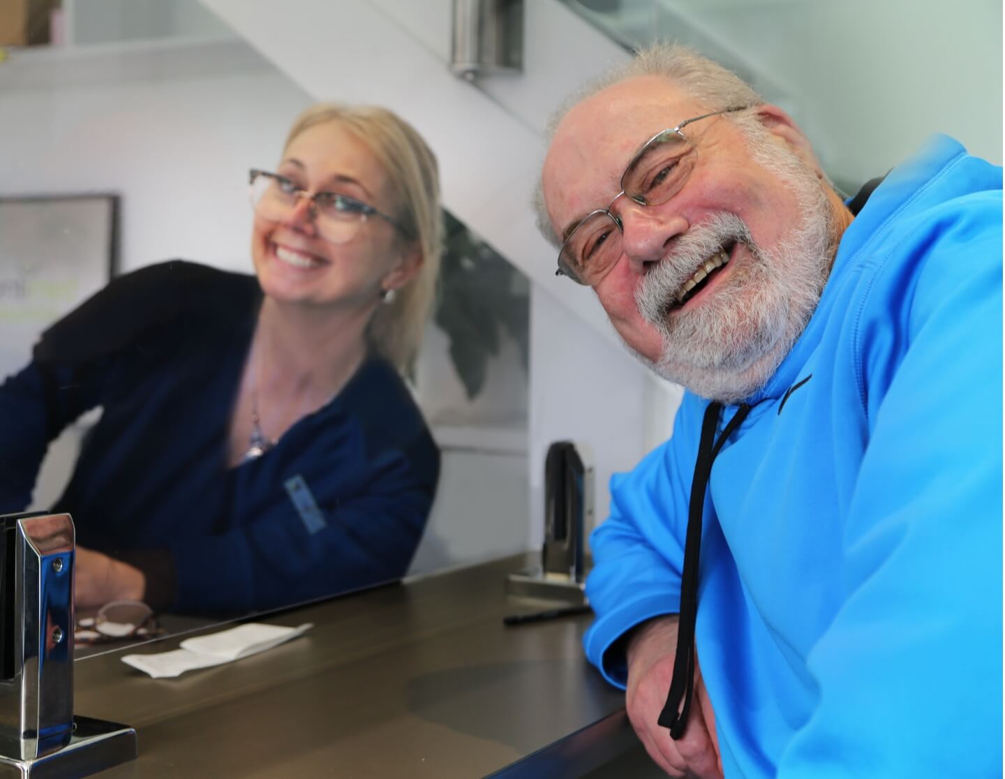 receptionist smiling with patient