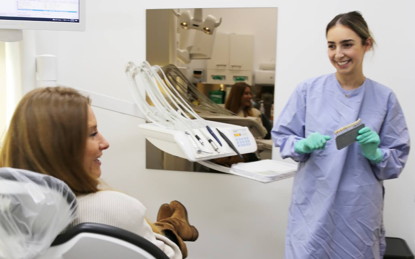 hygienist with patient in dental chair