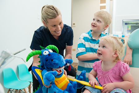 Oral Health Therapist and children in waiting room