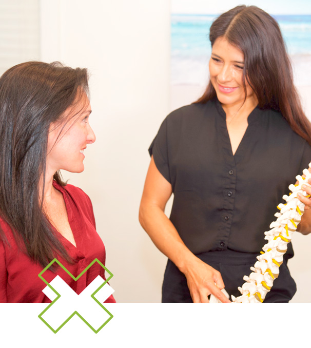 doctor showing spine model to patient