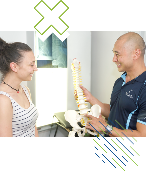 chiropractor smiling and talking with patient