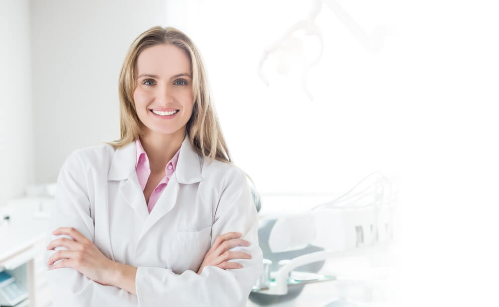 dentist smiling in white lab coat
