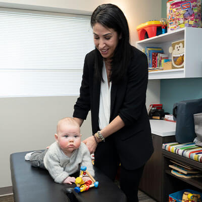 Dr Shara adjusting baby