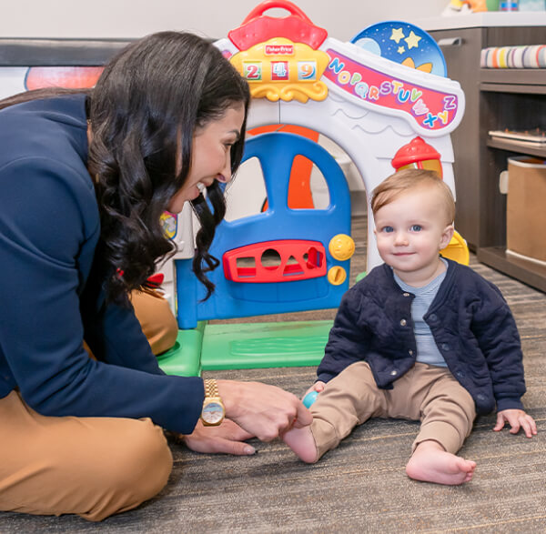 Dr. Shara playing with toddler