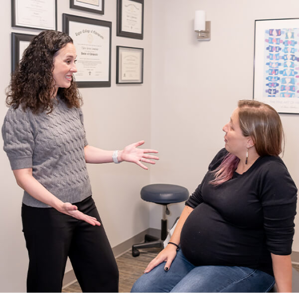 Chiropractor talking to pregnant patient