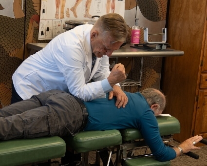 Chiropractic Care Chiropractor adjusting patient's back