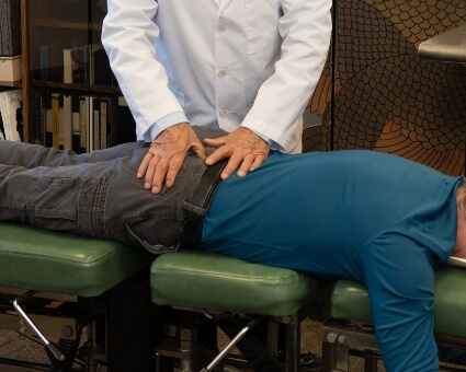 Chiropractic Care Lower-back adjustment blue shirt patient