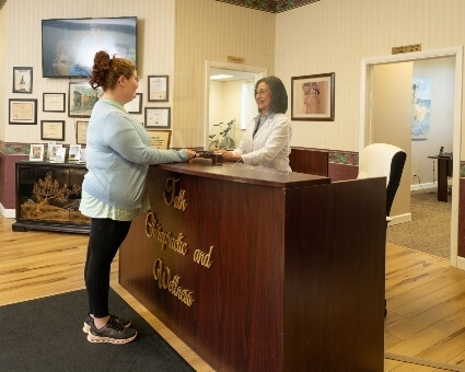 Receptionist greeting female patient