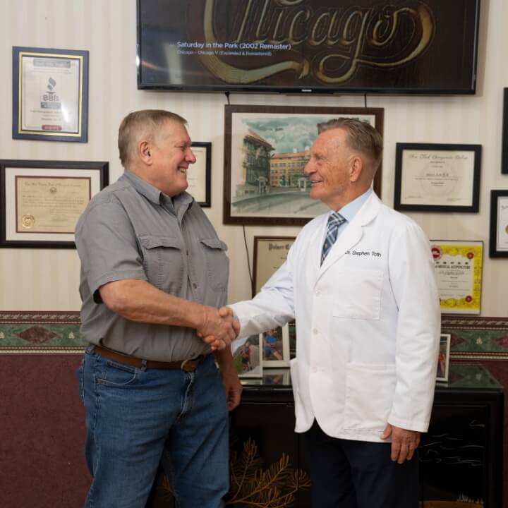 Morgantown chiropractor Dr. Toth shaking patient's hand