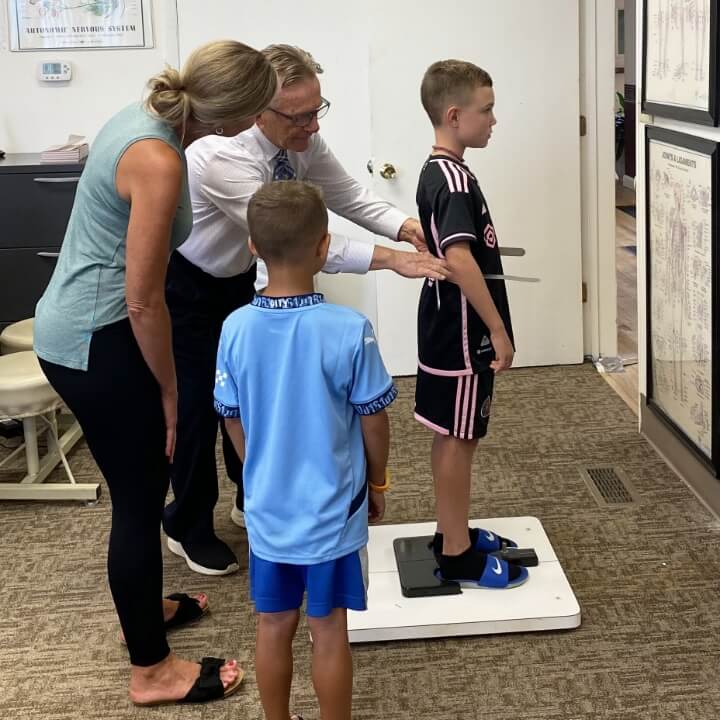 Morgantown chiropractor in consultation with a family