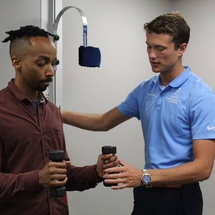 Dr. Preston assisting patient with sports rehab