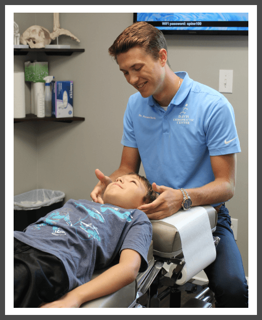 chiropractor adjusting patient